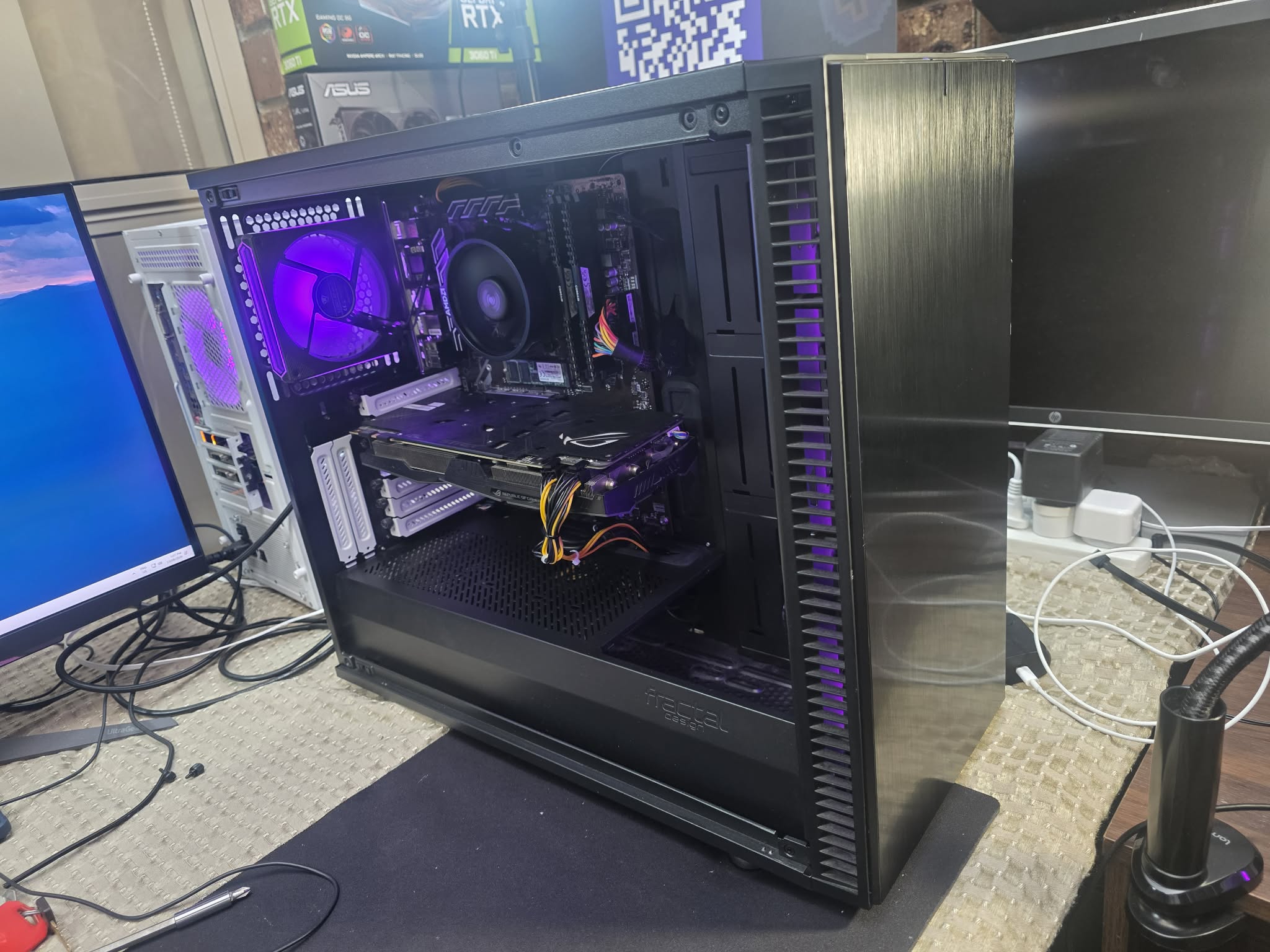Black tower with a brushed front and purple-lit interior.