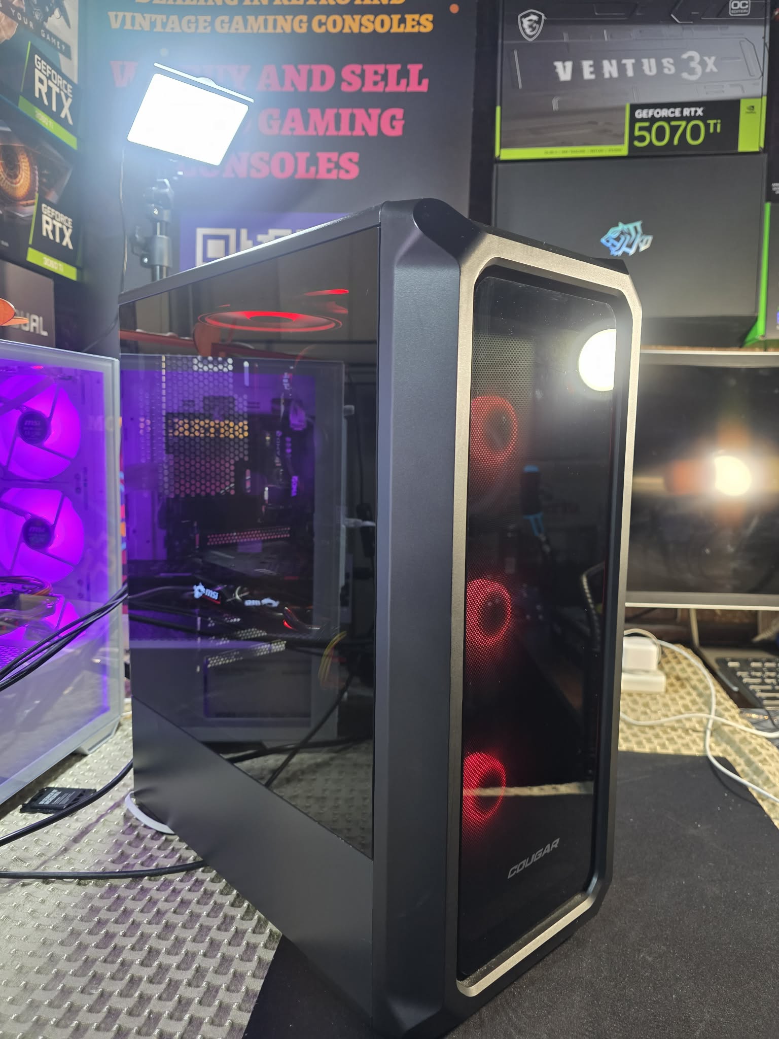 Black mesh-front tower with red fans.