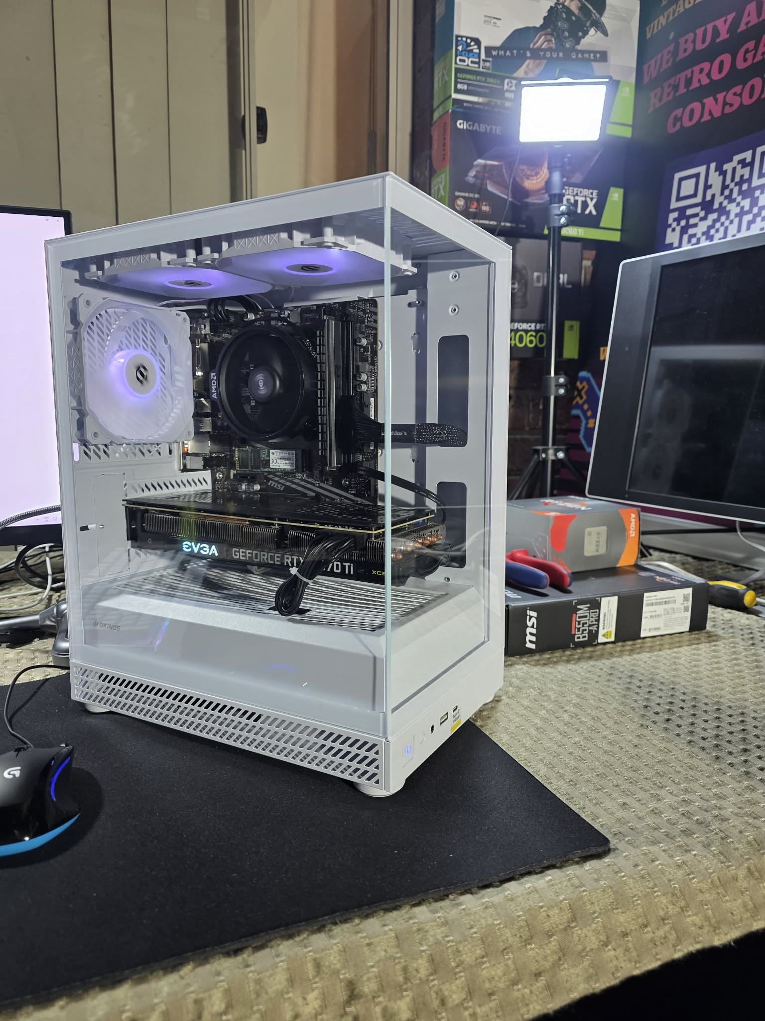 A compact white build with a glass front and side.
